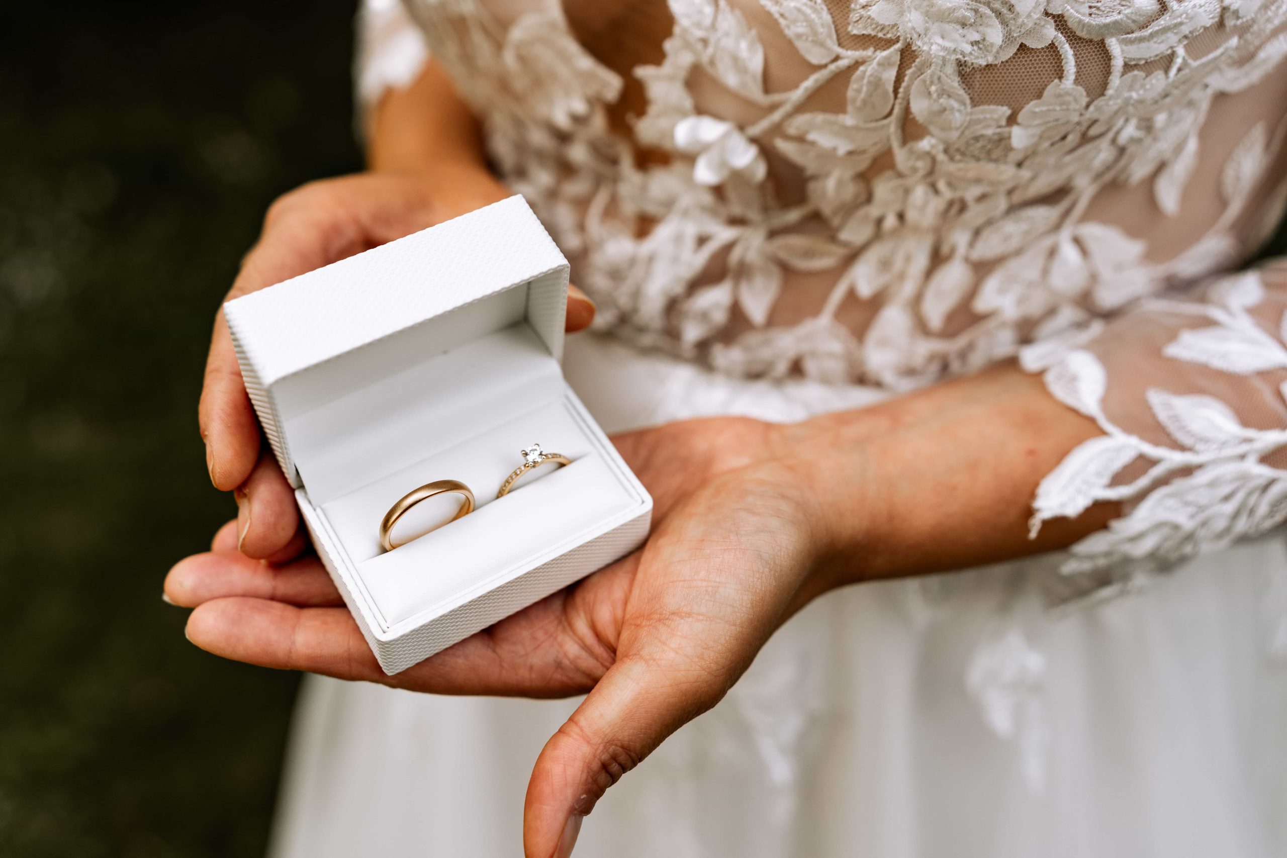Bruid laat trouwringen in doosje zien.