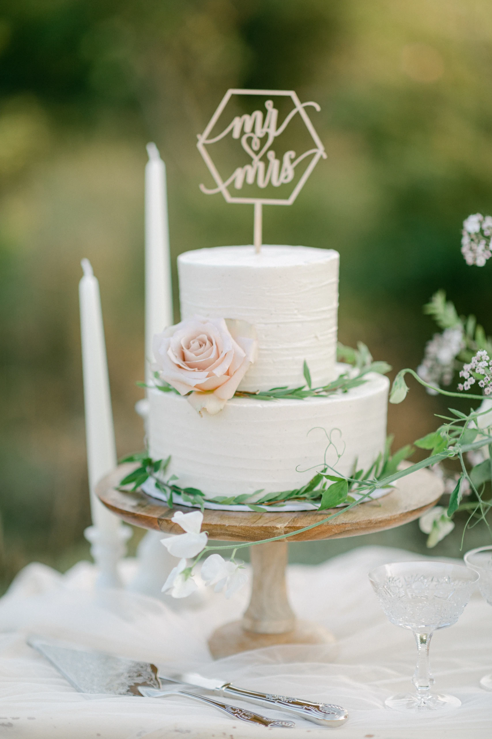 Witte bruidstaart met rozen en botanische decoratie