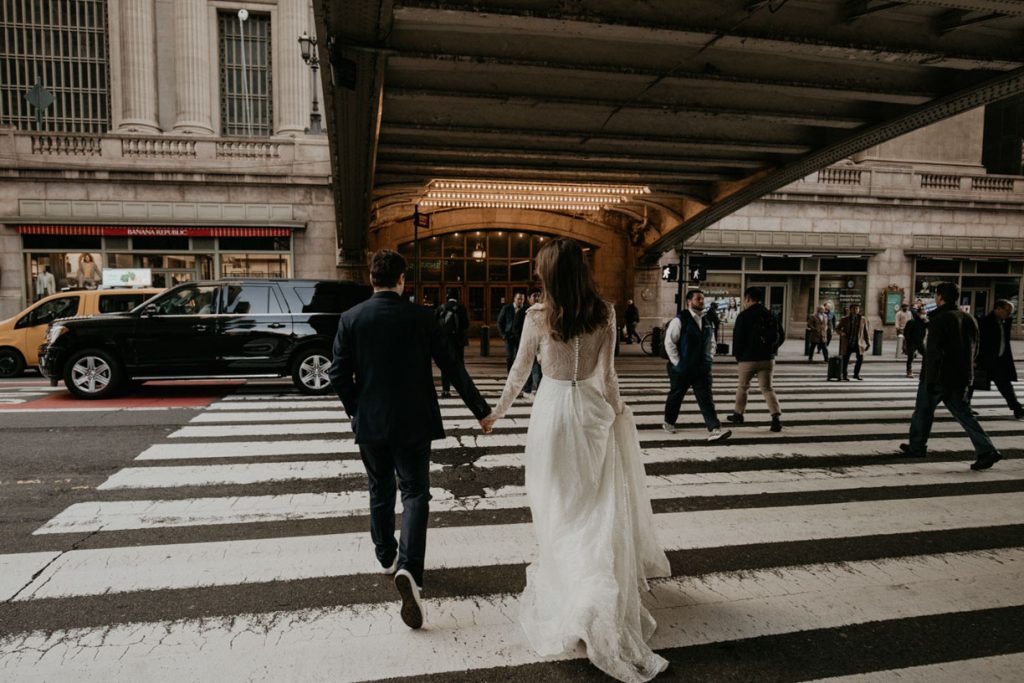 Bruidspaar loopt hand in hand over straat